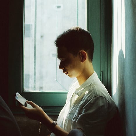 man-looking-at-his-phone